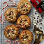 chocolate chip cookies and candy canes on a cooling rack next to a red car