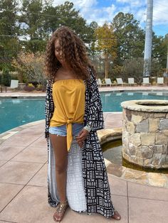 Looking for something unique and eye-catching? Check out our Danai Black Mud Print Long Sleeve Kimono! This beautiful piece is inspired by African mud prints, and is sure to turn heads wherever you go. The loose fit and long sleeves make it perfect for a variety of body types, and the ankle-length hem adds a touch of elegance. Dress it up or down, depending on your mood – either way, you're sure to look amazing! Product Details Material: 100% polyesterBelt: NoFit: loosePattern : PrintedShipping: