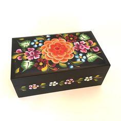 a black box with flowers painted on it