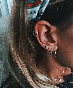 a close up of a person with ear piercings