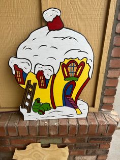 a sign that is on the side of a building with a snowman in it