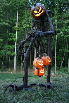 an image of a halloween decoration made out of branches and jack - o'- lanterns