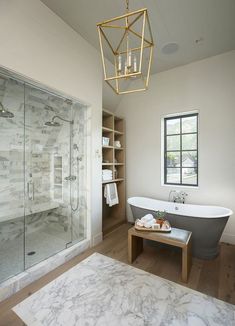 a bathroom with a bathtub, sink, and shower in the middle of it