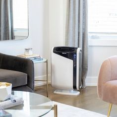 an air purifier sitting in the corner of a living room