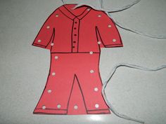 a paper cut out of a woman's pajama suit on a table