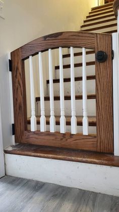 a wooden banister with white railings and wood handrail