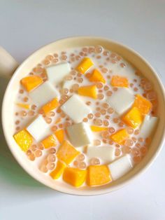 a white bowl filled with lots of different types of food on top of a table