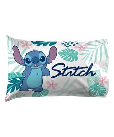 a pillow with the name stitch on it and an image of stitch in front of leaves