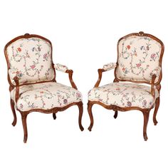 two chairs with floral upholstered back and arms