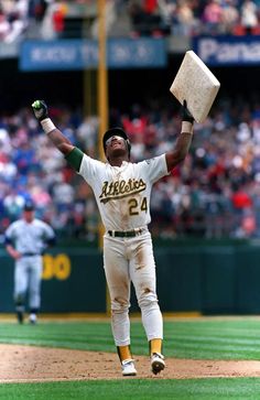 a baseball player is jumping in the air with his bat and glove raised above his head