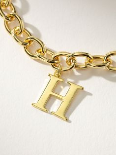 You’ll be unforgettable in this gold initial bracelet. Crafted from a gold chain bracelet and an initial pendant, our Remember Me Bracelet deserves a spot in your jewelry collection. For a fully personalized look, shop our Initial Jewelry Collection. | Gold Initial Remember Me Chain Bracelet with Letter E | Women's Jewelry by Uncommon James Gold Chain Bracelet With Logo Charm As Gift, Trendy Gold Jewelry With Monogram, Trendy Gold Monogram Jewelry, Luxury Gold Bracelets With Initials, Initial Bracelet J, Enamel Letter Bracelet, Personalized Gold Charm Bracelet With Initials, Adjustable Gold Charm Bracelet With Initials, Adjustable Gold Letter Bracelet