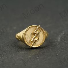 a gold ring with the symbol of the flash on it's center and a lightning bolt in the middle