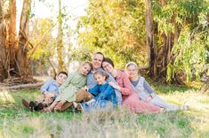 a family sitting in the grass together