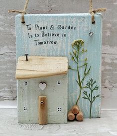 a wooden sign that says to plant a garden is to believe in tomorrow with flowers