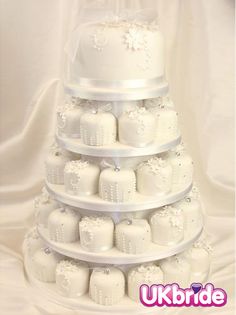 a tiered cake with white frosting on it