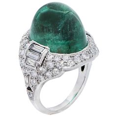 Classic Art Deco ring set with a sugarloaf cabochon emerald, with an AGL certificate stating its weight is 14.76 carats and the emerald is Colombian with minor traditional treatment. Round and baguette diamonds adorn the platinum ring. Ring Size: 5 (can be sized) Metal: Platinum (stamped and/or tested) Metal Weight: 9.7 Grams Antique Cocktail Ring, Emerald Diamond Ring, Jewels Rings, Colombian Emeralds, Diamond Cocktail Rings, Cabochon Ring, Deco Jewelry, Bling Rings, Antique Diamond