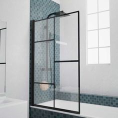 a glass shower door in a bathroom with blue tiles on the walls and below it is a white sink