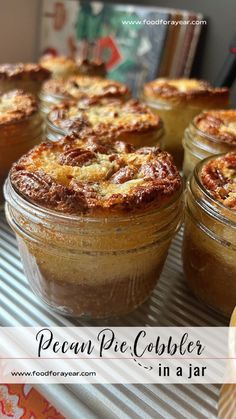 several jars filled with pies sitting on top of a refrigerator