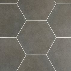 a tile floor with hexagonal tiles in grey and white lines on the bottom