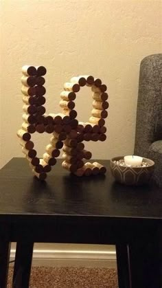 a table with a bowl on it and a sculpture made out of chocolates in the shape of letters