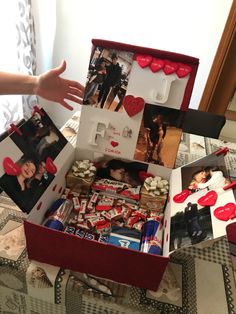 an open box filled with pictures and hearts