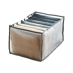 an open storage bag with four folded shirts in it's bottom section on a white background