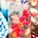 a mason jar filled with berries and blueberries