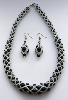 a black and white beaded necklace and earring set with matching earrings on display