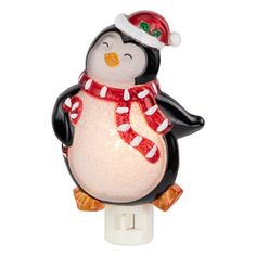 a light up penguin wearing a santa hat and scarf