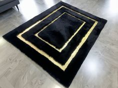 a black and gold rug on the floor in a living room