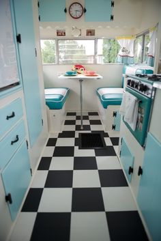 a kitchen with black and white checkered flooring next to a stove top oven