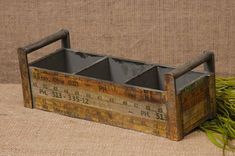 an old wooden box with three bins on the bottom and one in the middle