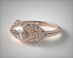 a white gold engagement ring with an oval cut diamond surrounded by pave set diamonds