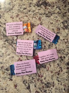 some candy bars that are on top of a granite counter with notes attached to them