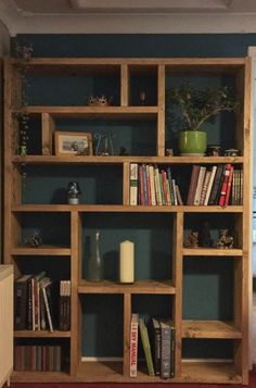 a bookshelf filled with lots of books in a living room next to a window