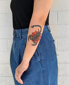 a woman with a scorpion tattoo on her arm