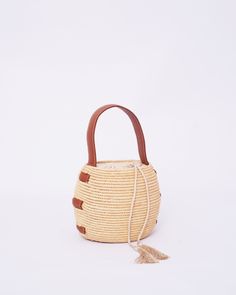 Do you want to look stylish and hippy? Get your hands on this handmade straw bag. It's high quality, eco-friendly, and handcrafted by women in Morocco. Its design is unique and timeless. Get yours now! we are proud to introduce our signature straw french bag to you. it is handmade by our talented artisan who has been working with us for years. this beautiful bag has a unique design that you would find nowhere else. the light and durable material are ideal for taking the bag on your adventures. S Raffia Bucket Bag, Straw Bucket Bag, French Basket, Moroccan Basket, Woven Purse, Raffia Bag, Top Handle Bags, Leather Accents, Handmade Bag