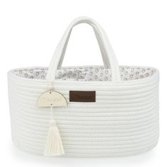 the large white basket has a tasselled handle