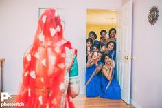 a group of women standing in front of a doorway