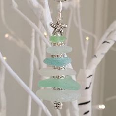 a glass ornament hanging from a white tree