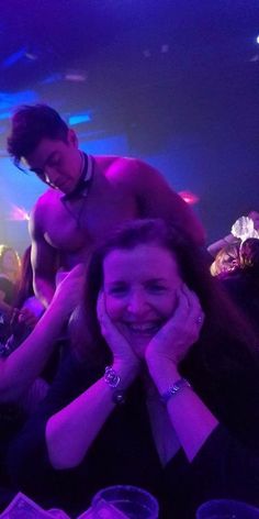 a woman sitting on top of a man's shoulders at a party