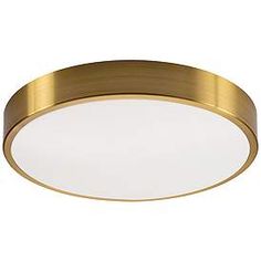 a round light fixture with a gold finish and white glass diffuses on the ceiling