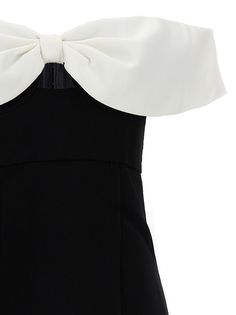 a black and white dress with a bow on the back