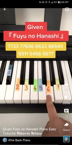 a person is playing the piano with numbers on it and an app that says give fufu no hanashi