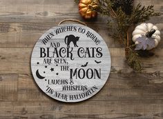 a wooden sign that says, when witches go riding and black cats are seen the moon laughs & whispers is near halloween