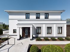 a white two story house with black shutters