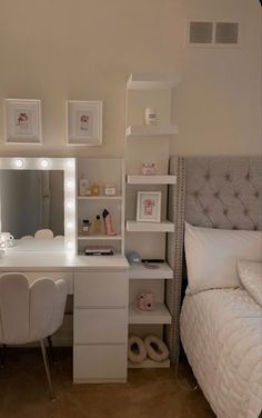 a bedroom with a bed, desk and mirror on the wall next to each other