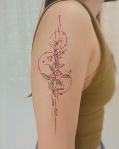 a woman with a tattoo on her arm has flowers in the shape of a heart