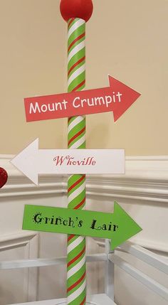 a street sign that has some signs on it with arrows pointing in different directions and the words mount crumpi, wyrcelle, grin's lawn