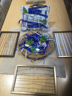 the table is set up with blue and white plates, napkins, and pictures